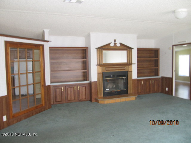 15595 Bream Road Jacksonville, FL 32226 - Photo 2 of 3 a view of an empty room with a fireplace and a window