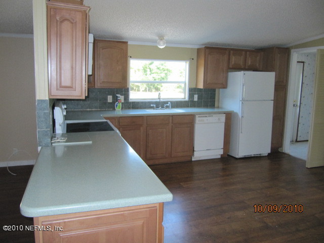 15595 Bream Road Jacksonville, FL 32226 - Photo 3 of 3 a kitchen with stainless steel appliances a refrigerator sink and cabinets
