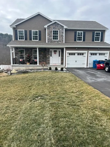 a view of a white house with large windows and a table