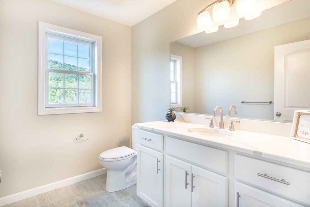 12 Upper Palmer Road Monson, MA 01057 - Photo 13 of 39 a bathroom with a toilet a sink a mirror a vanity and a window