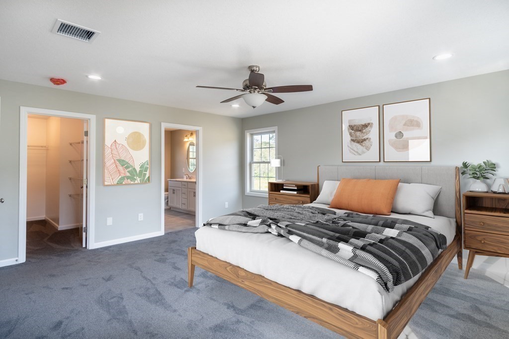 12 Upper Palmer Road Monson, MA 01057 - Photo 14 of 39 a bedroom with a large bed and a chandelier