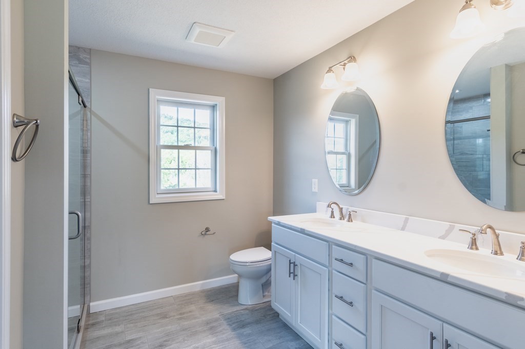 12 Upper Palmer Road Monson, MA 01057 - Photo 18 of 39 a bathroom with a double vanity sink mirror and toilet