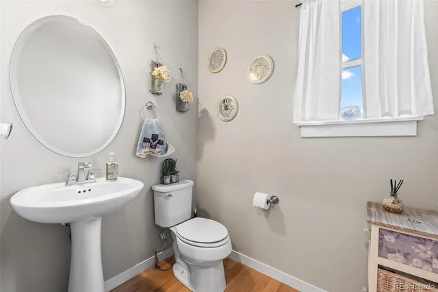 a bathroom with a sink mirror and toilet
