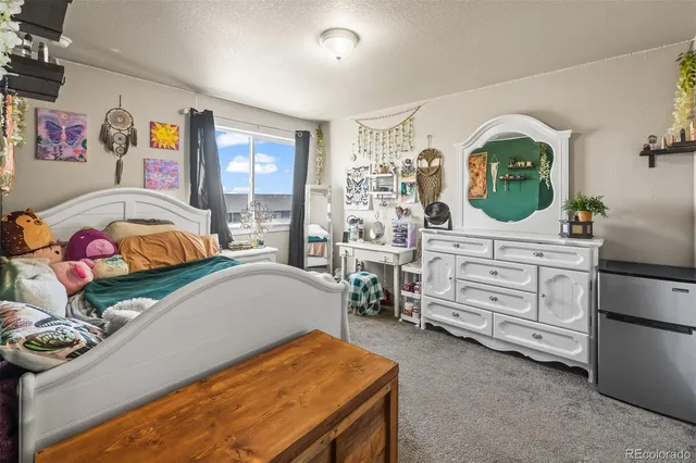 a bedroom with furniture and flowerpot