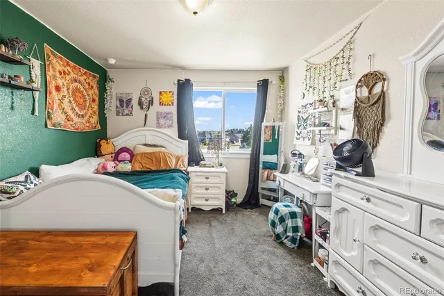 a bedroom with furniture and a window