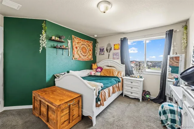 a bedroom with bed and a window