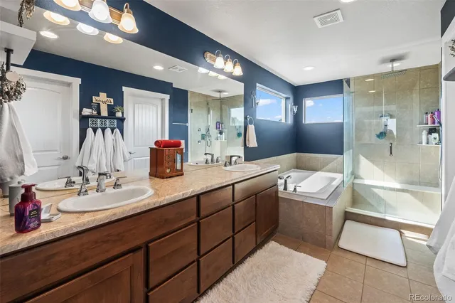 a bathroom with a tub sink and mirror