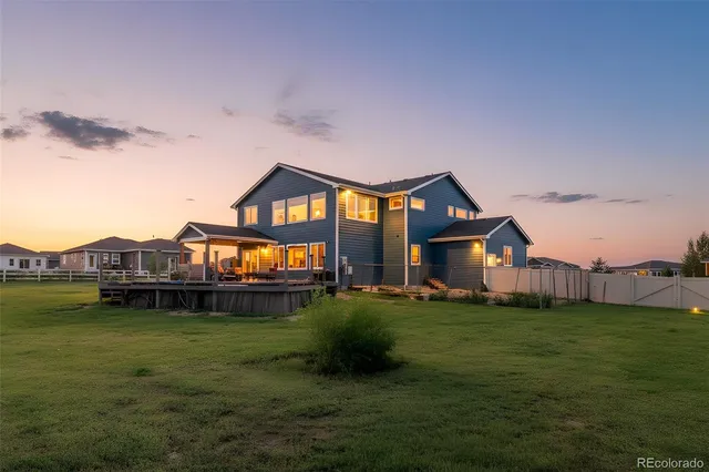 a view of a house with a big yard and large trees