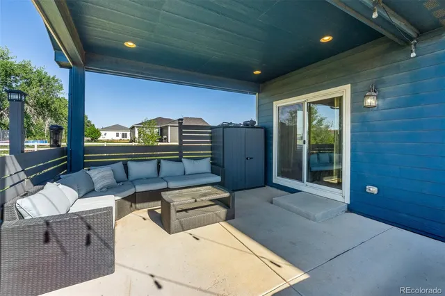 a building outdoor space with patio furniture and potted plants