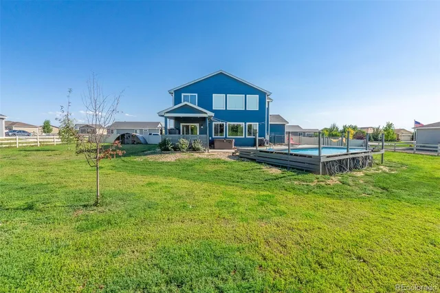a view of a house with a yard table and chairs