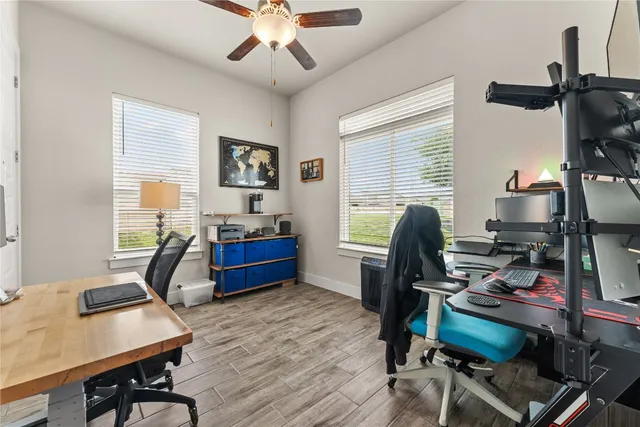 a view of a workspace with furniture and a window