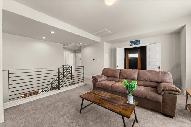 a living room with furniture and a ceiling fan