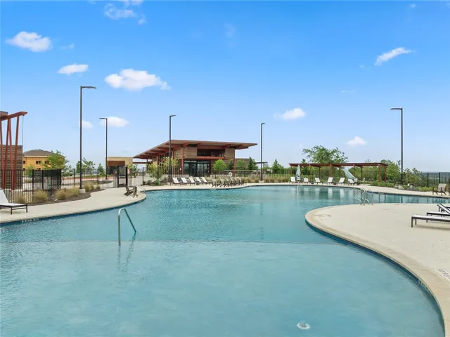 a view of a swimming pool with chairs