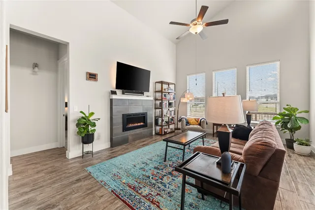 a living room with furniture a fireplace and a flat screen tv