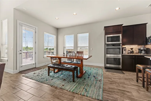 a living room with furniture a flat screen tv and a table