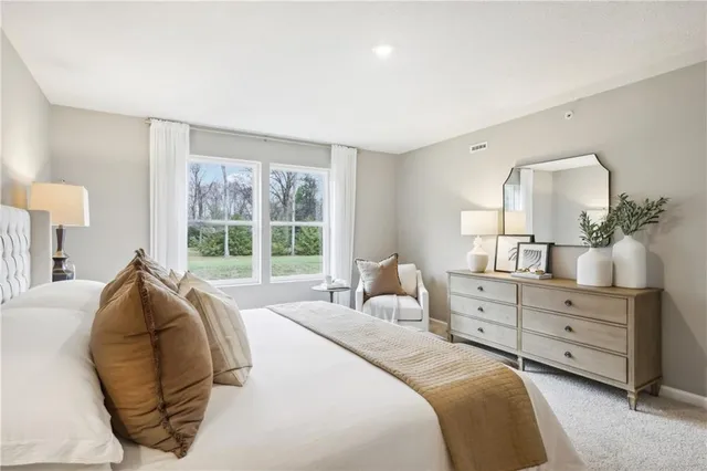 a bedroom with a bed and window