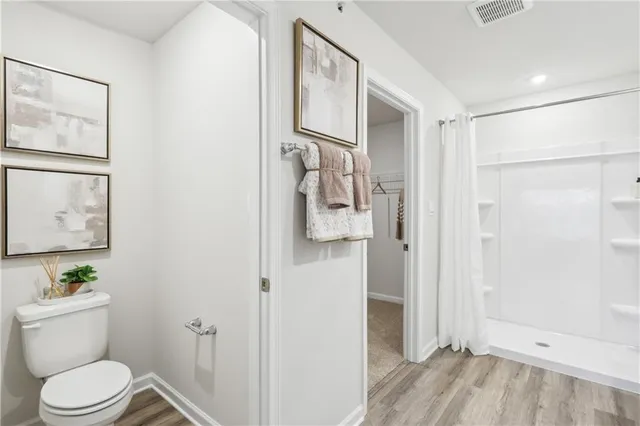 a white toilet sitting next to a bathroom sink