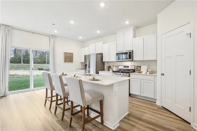 a kitchen with appliances a sink and cabinets