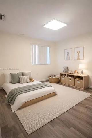 a spacious bedroom with a bed and a cabinets