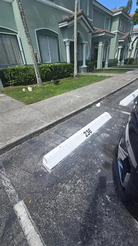 a view of a house with a yard and plants