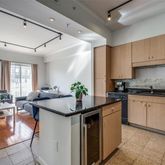 a kitchen with stainless steel appliances granite countertop a sink dishwasher stove and white cabinets with wooden floor