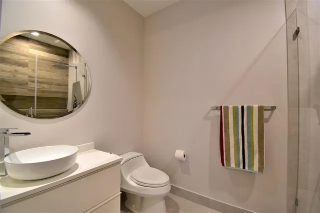 a large kitchen with kitchen island a large counter top space a sink stainless steel appliances and cabinets