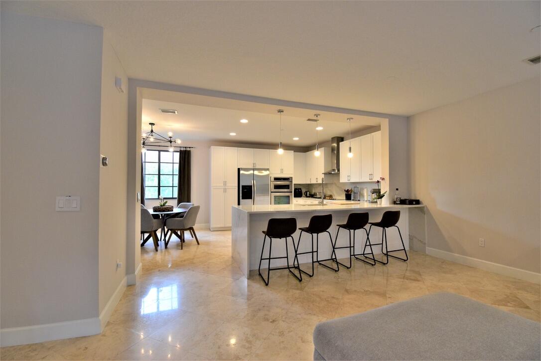4866 Northwest 16th Avenue Boca Raton, FL 33431 - Photo 14 of 68 a view of a dining room with furniture and chandelier