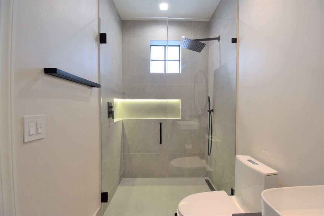 4866 Northwest 16th Avenue Boca Raton, FL 33431 - Photo 33 of 68 a bathroom with a toilet and shower