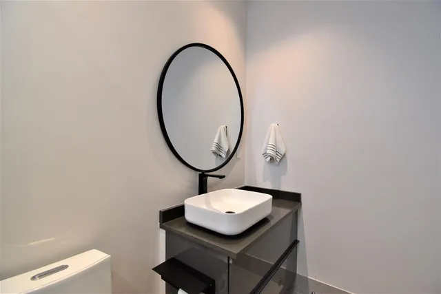 a bathroom with a toilet sink and mirror