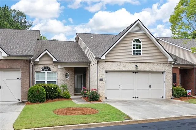a view of a house with a yard and garage