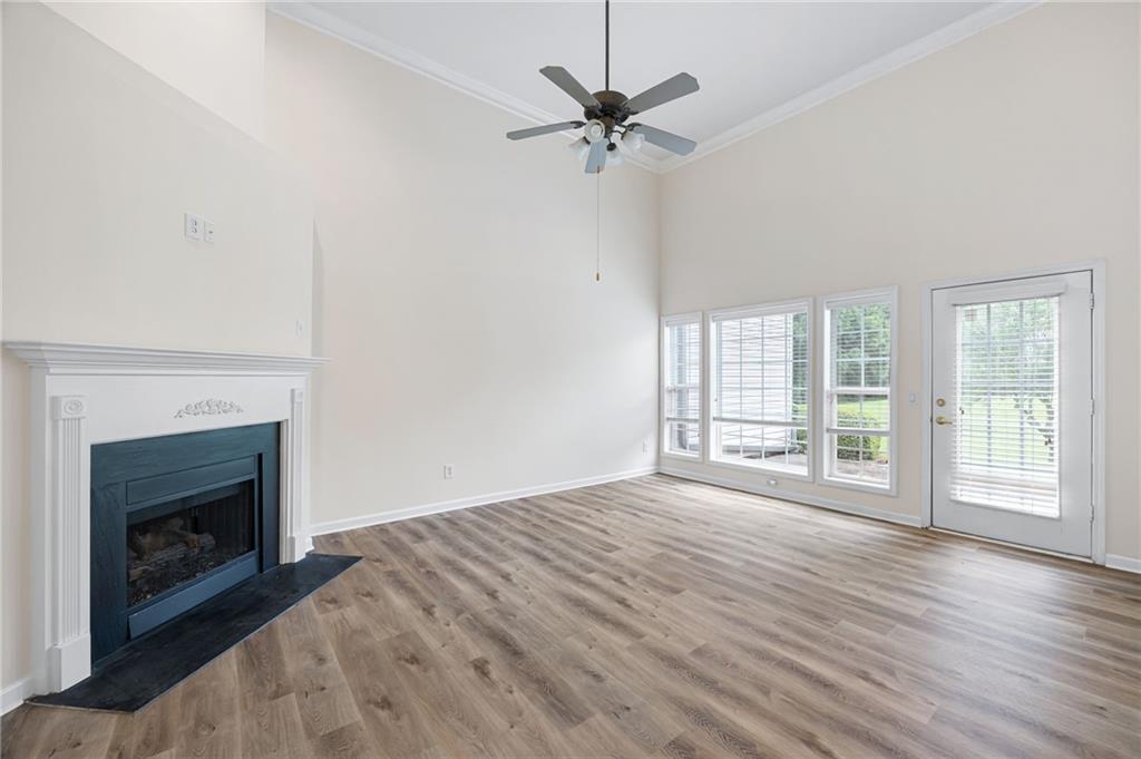 3832 Abbott Lane, Unit 1 Powder Springs, GA 30127 - Photo 15 of 37 a view of an empty room with wooden floor fireplace and a window