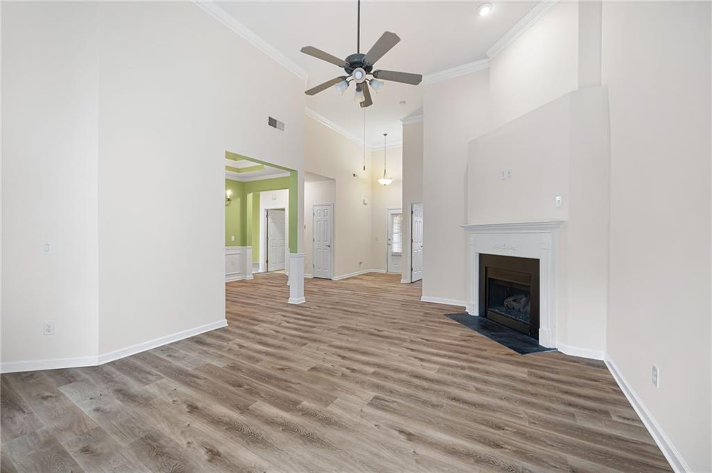 3832 Abbott Lane, Unit 1 Powder Springs, GA 30127 - Photo 16 of 37 a view of an empty room with a fireplace and a chandelier fan
