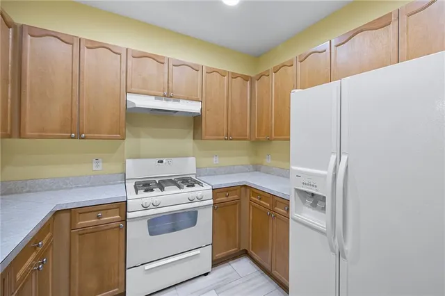 a kitchen with a stove and a refrigerator