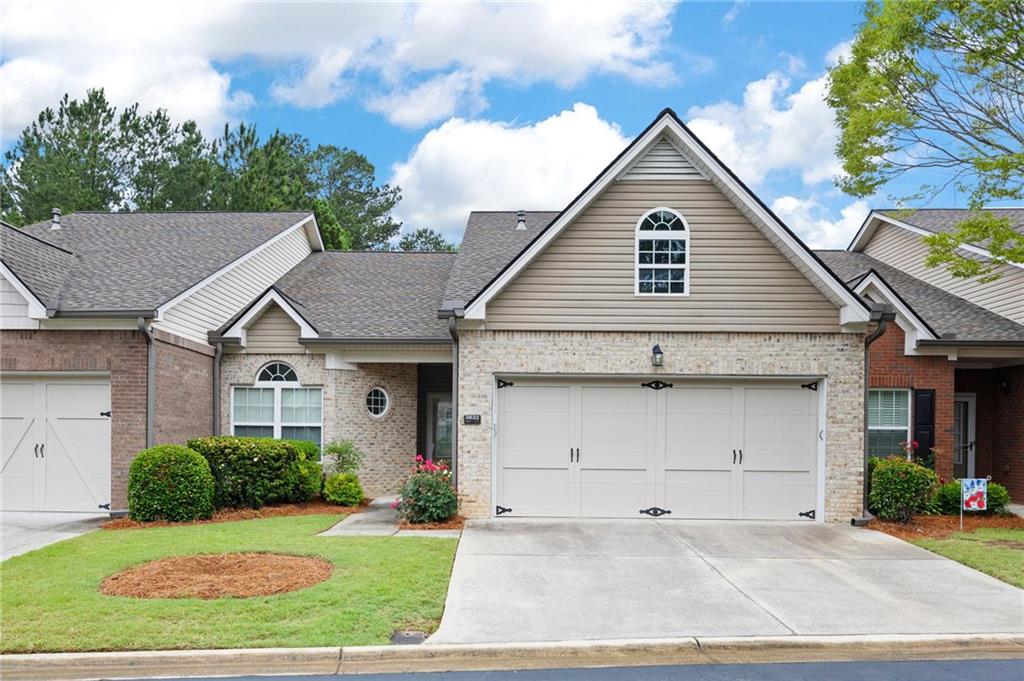 3832 Abbott Lane, Unit 1 Powder Springs, GA 30127 - Photo 2 of 37 a view of a white house in front of a yard with potted plants