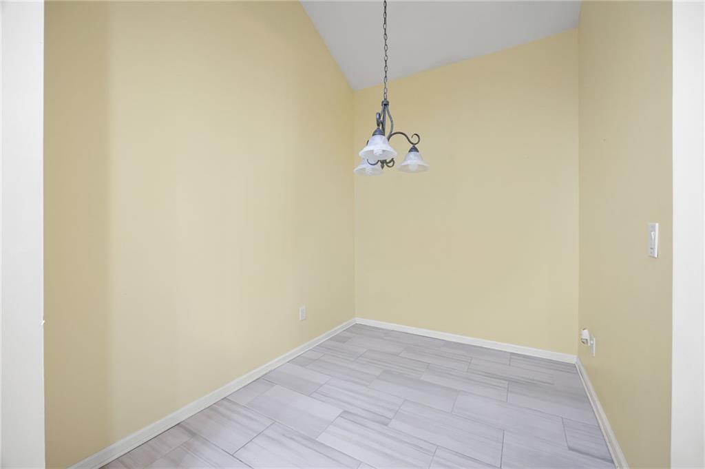 3832 Abbott Lane, Unit 1 Powder Springs, GA 30127 - Photo 21 of 37 an empty room with a chandelier fan