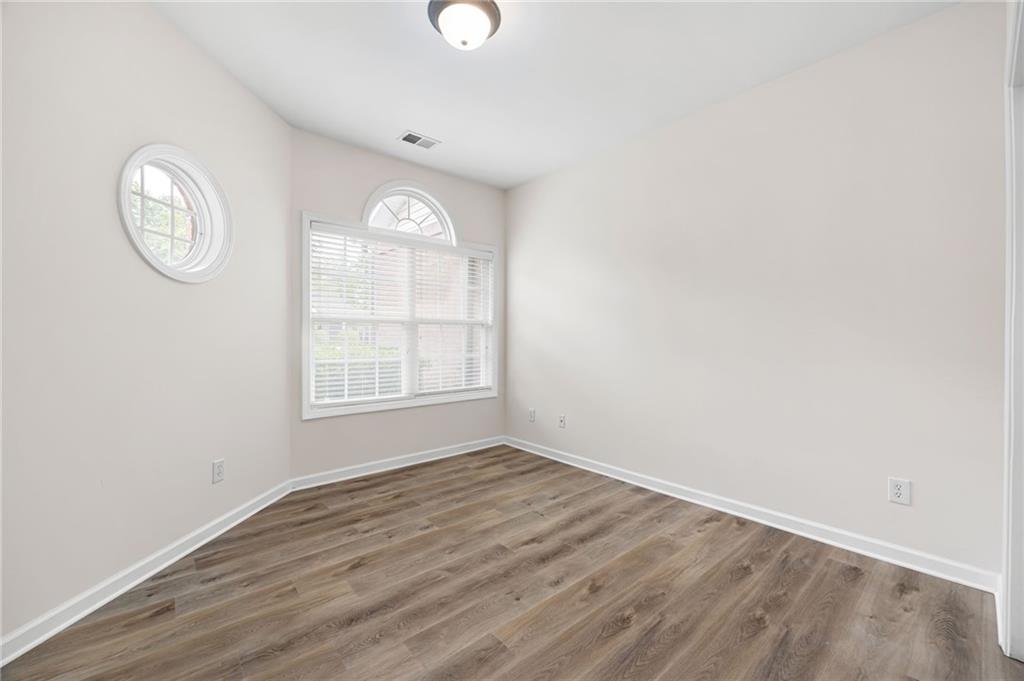 3832 Abbott Lane, Unit 1 Powder Springs, GA 30127 - Photo 23 of 37 an empty room with wooden floor and a window