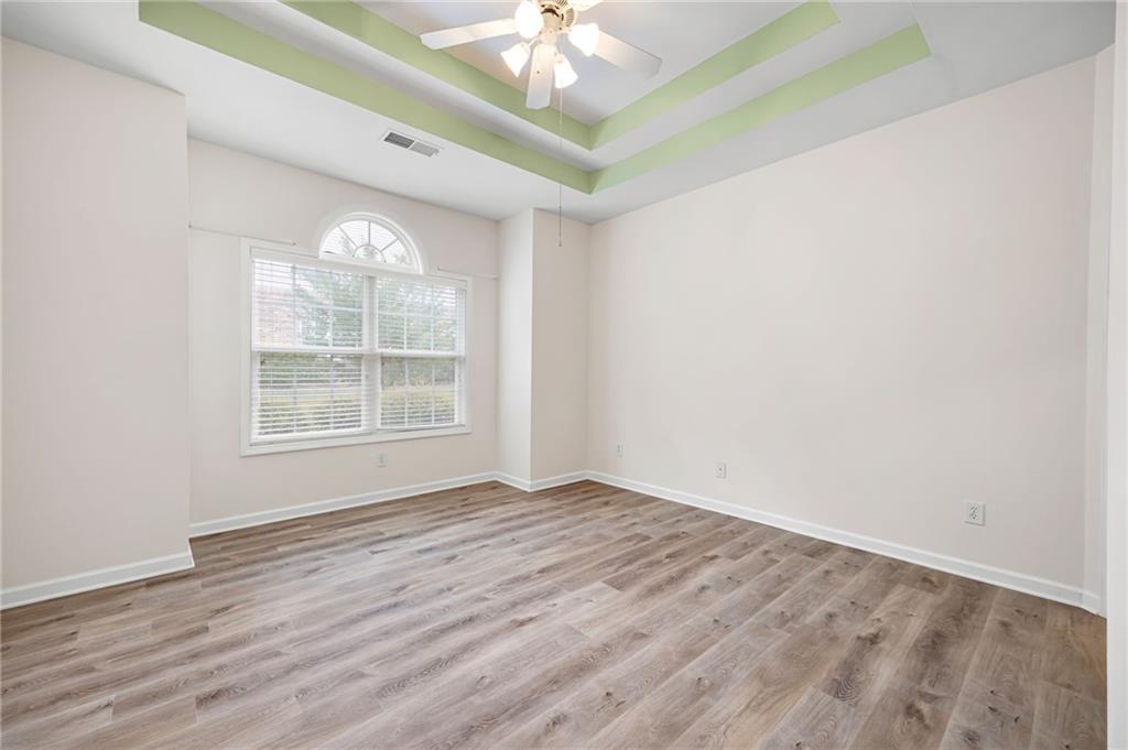 3832 Abbott Lane, Unit 1 Powder Springs, GA 30127 - Photo 25 of 37 a view of an empty room with a window and wooden floor