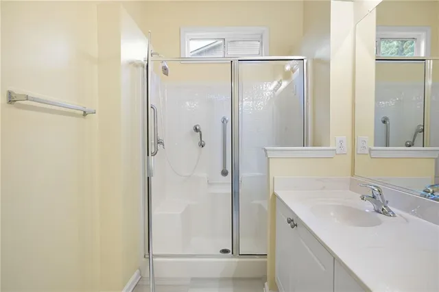 a bathroom with a shower sink and mirror