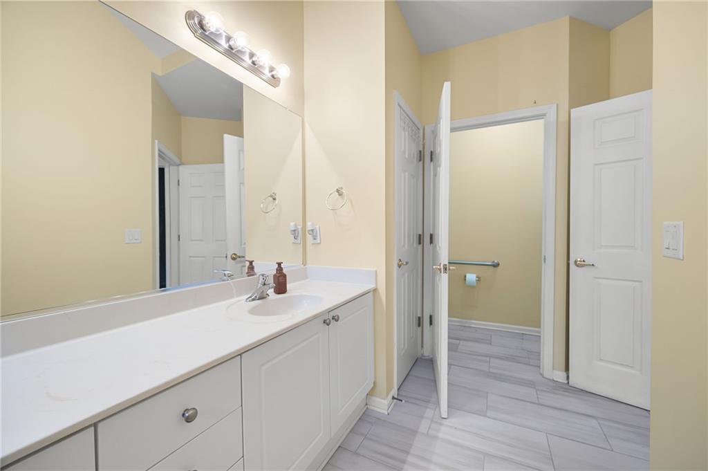 3832 Abbott Lane, Unit 1 Powder Springs, GA 30127 - Photo 30 of 37 a bathroom with a sink and a mirror