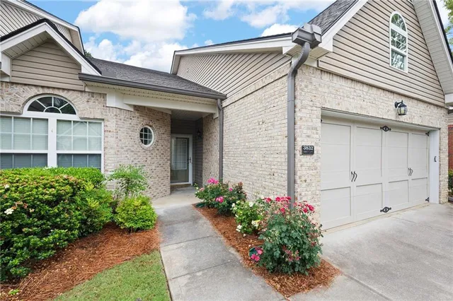 a front view of a house with a garden