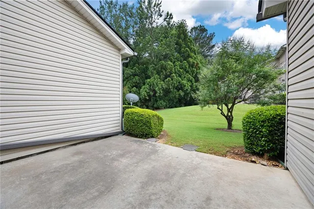 a view of a house with backyard and a tree