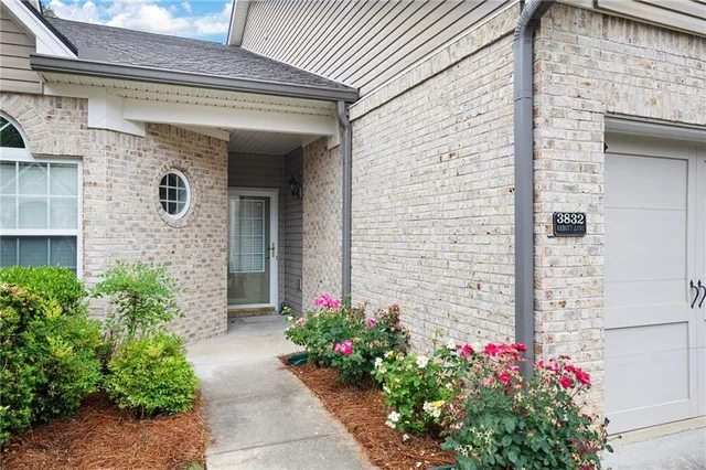 a front view of a house with a garden