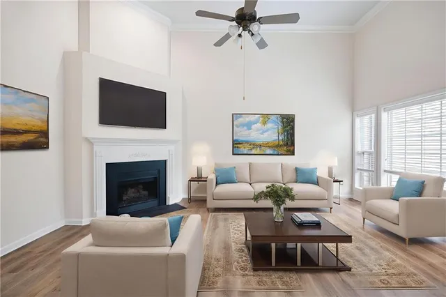 a living room with furniture a flat screen tv and a fireplace
