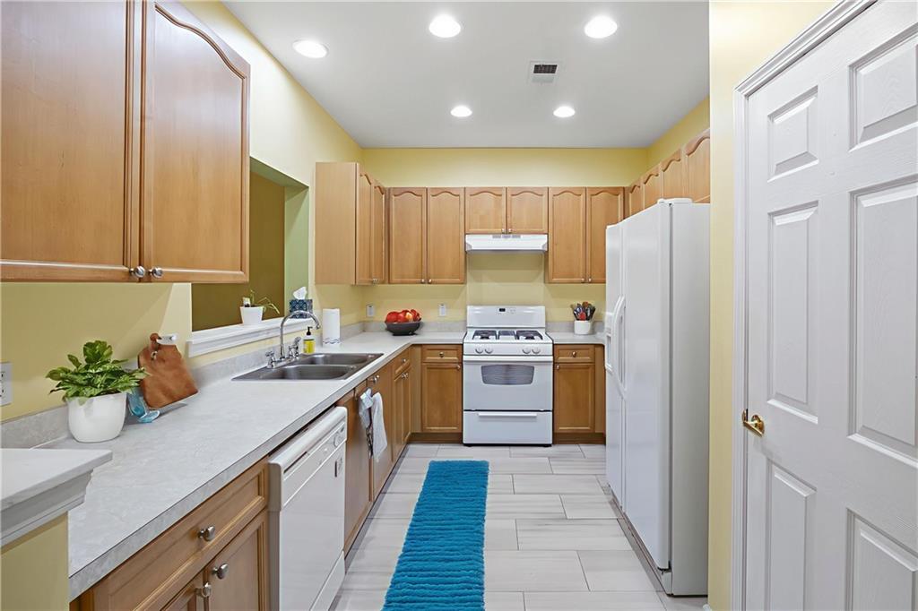 3832 Abbott Lane, Unit 1 Powder Springs, GA 30127 - Photo 6 of 37 a kitchen with stainless steel appliances a refrigerator sink and cabinets