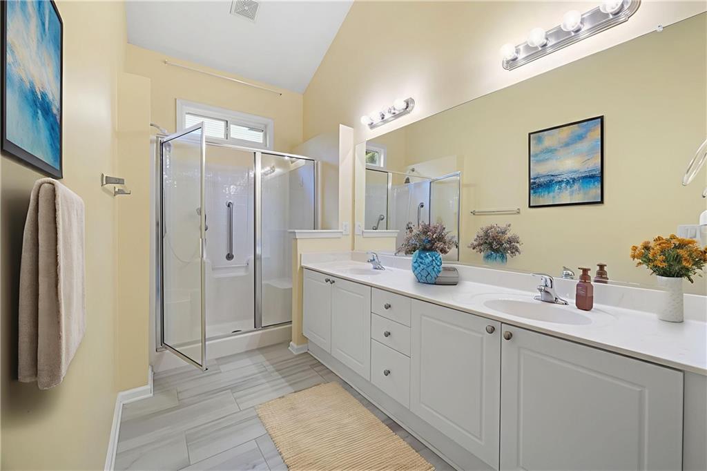 3832 Abbott Lane, Unit 1 Powder Springs, GA 30127 - Photo 9 of 37 a bathroom with a double vanity sink mirror and shower