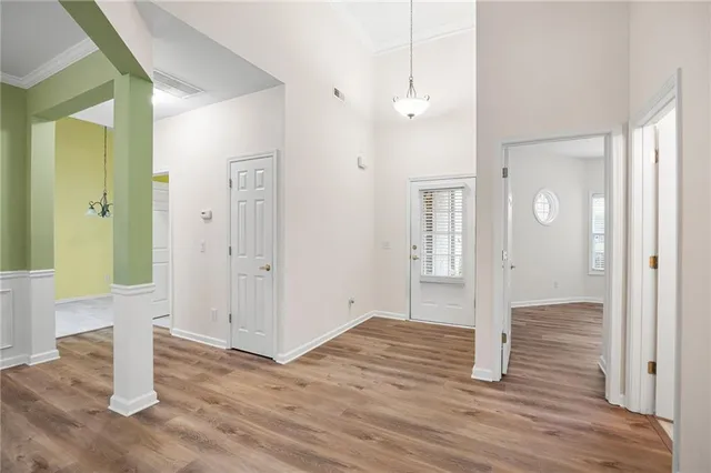 a view of empty room with wooden floor