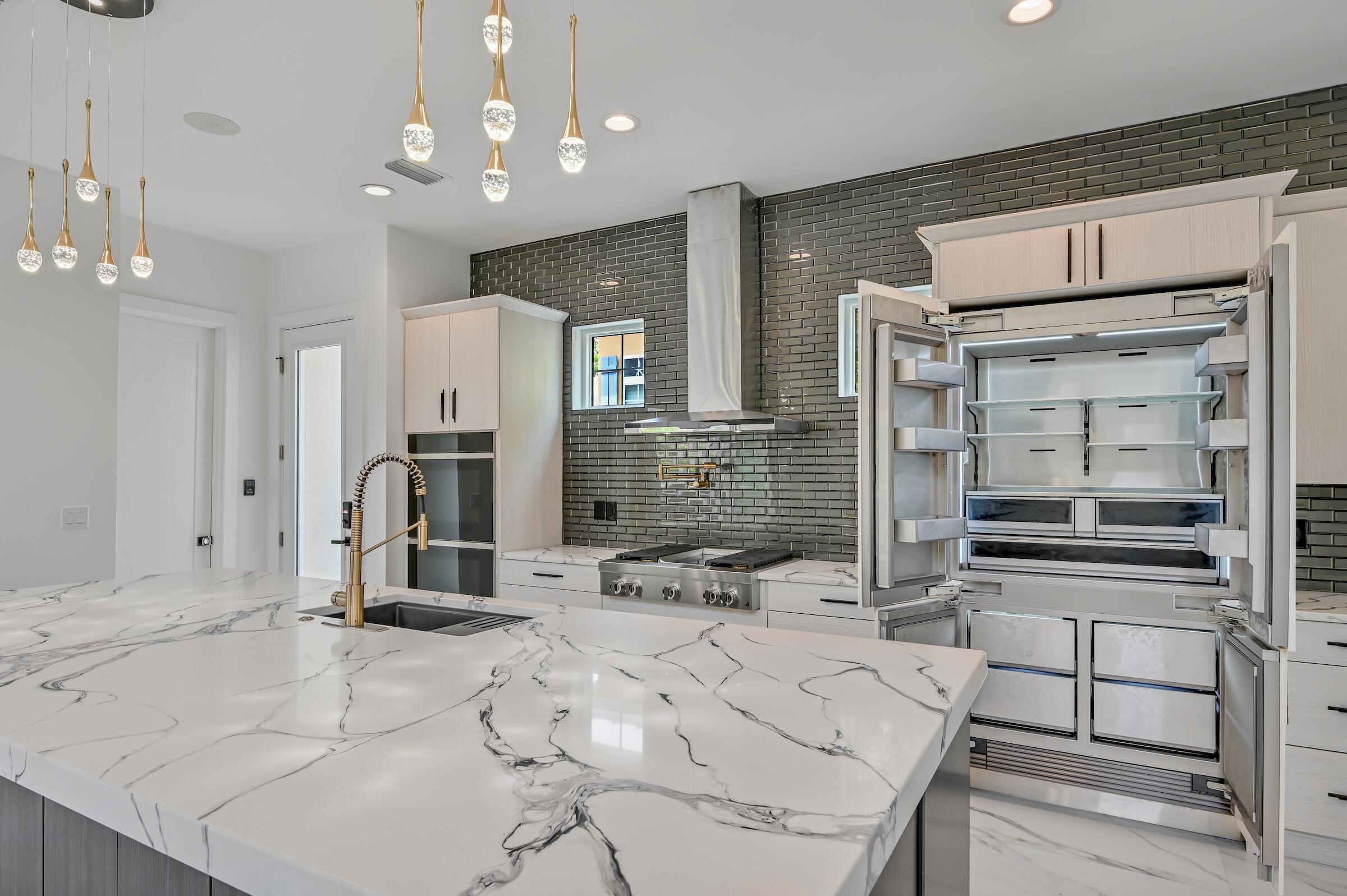 80 Rue Martine Miramar Beach, FL 32550 - Photo 13 of 54 a kitchen with stainless steel appliances kitchen island granite countertop a sink and cabinets