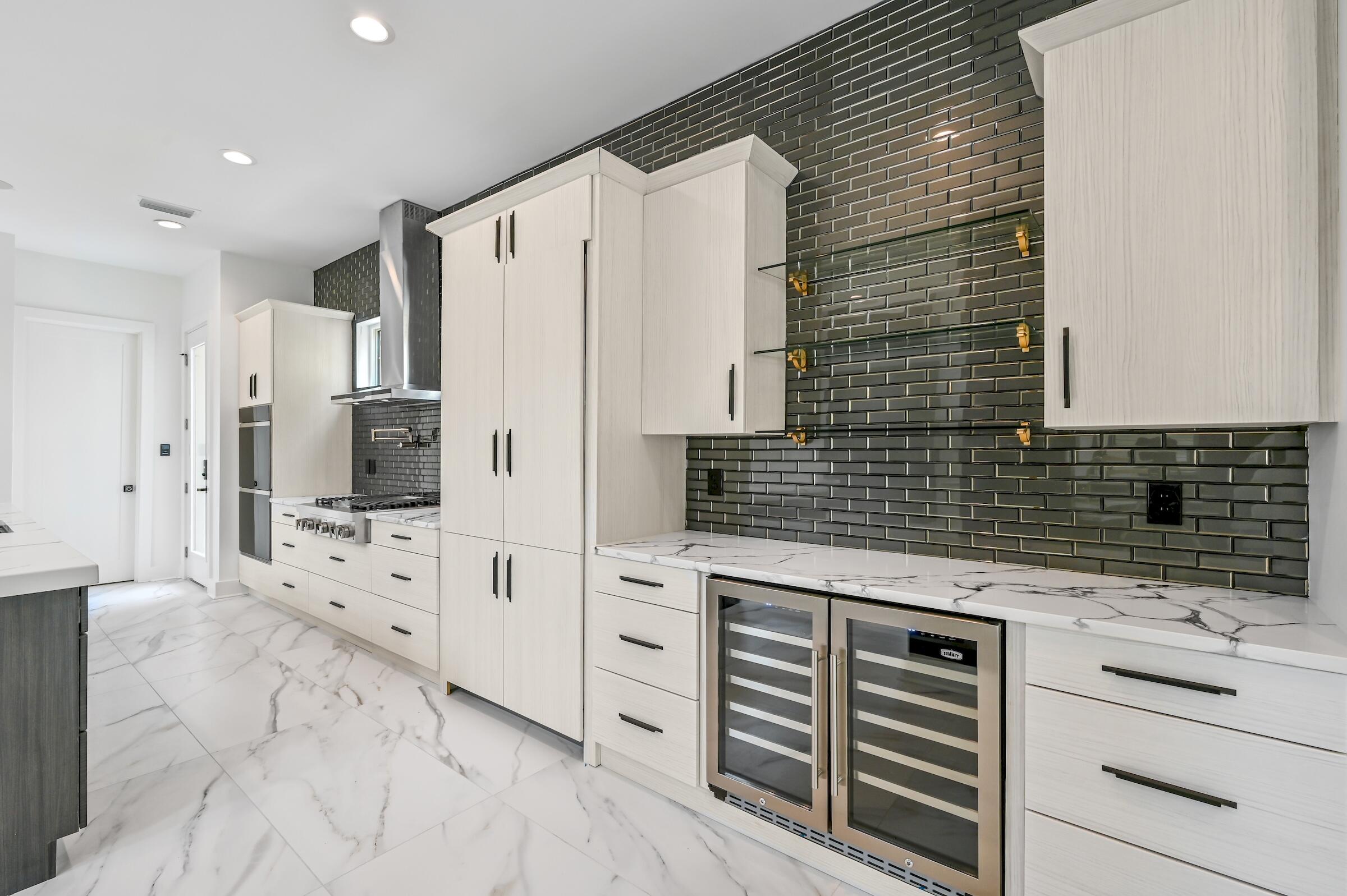 80 Rue Martine Miramar Beach, FL 32550 - Photo 15 of 54 a kitchen with white cabinets and stainless steel appliances