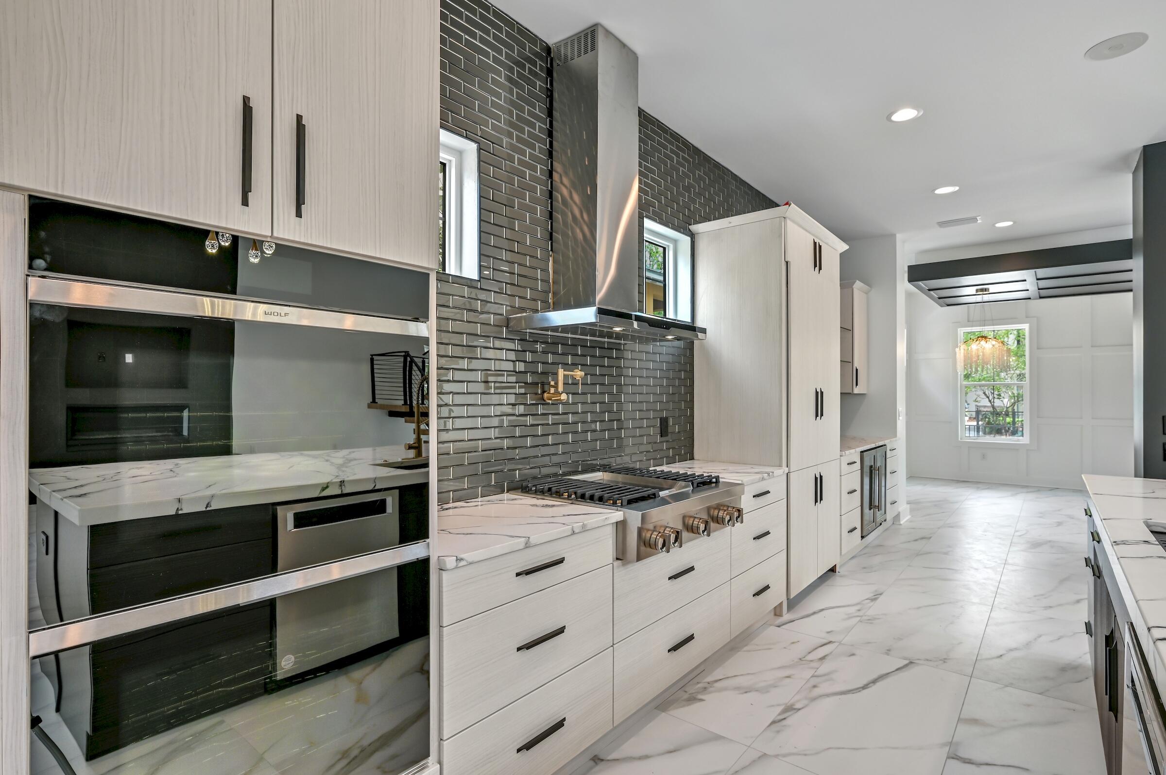 80 Rue Martine Miramar Beach, FL 32550 - Photo 21 of 54 a kitchen with stainless steel appliances kitchen island granite countertop a stove and a refrigerator