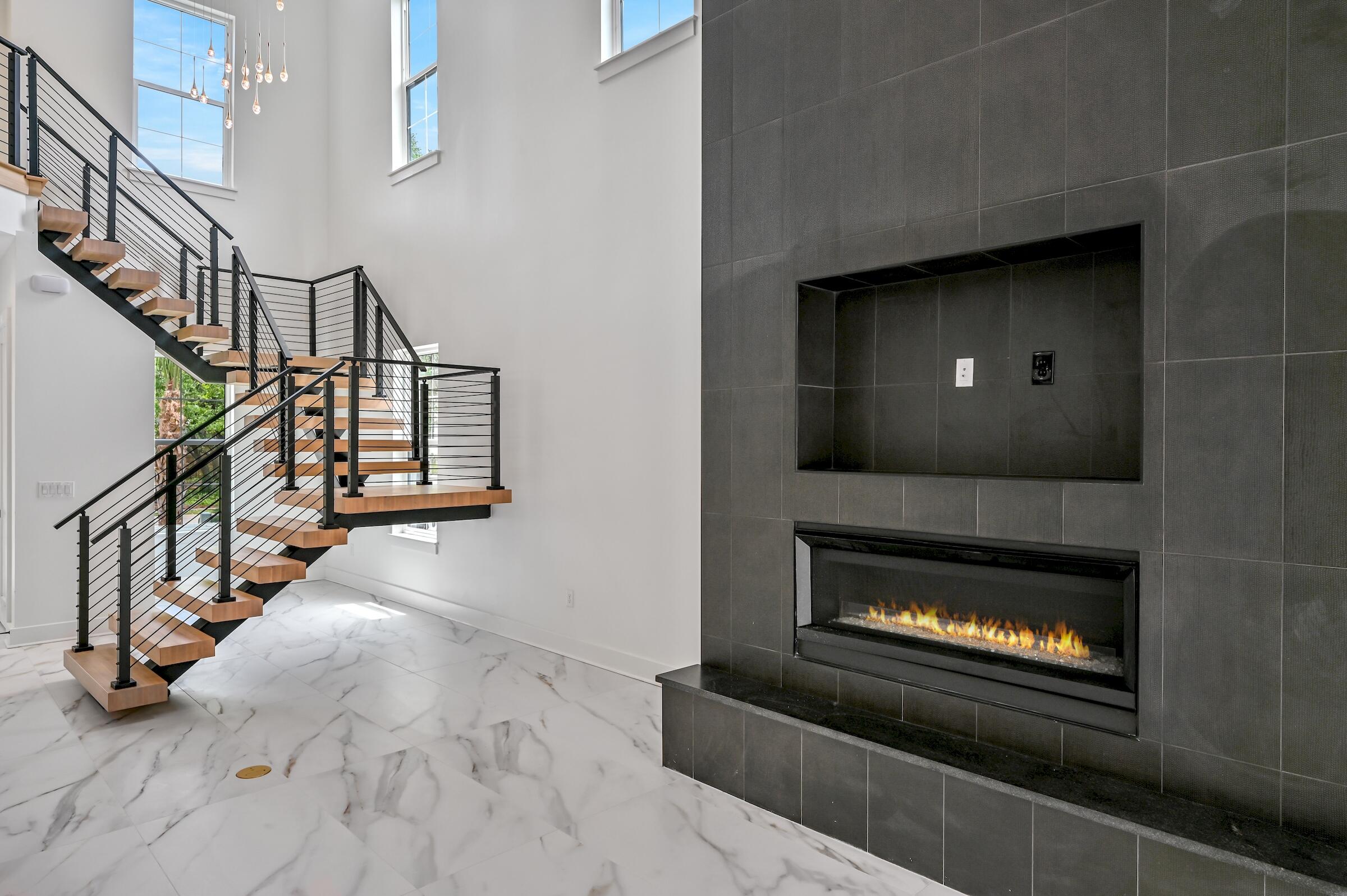 80 Rue Martine Miramar Beach, FL 32550 - Photo 27 of 54 a living room with stairs and a fireplace